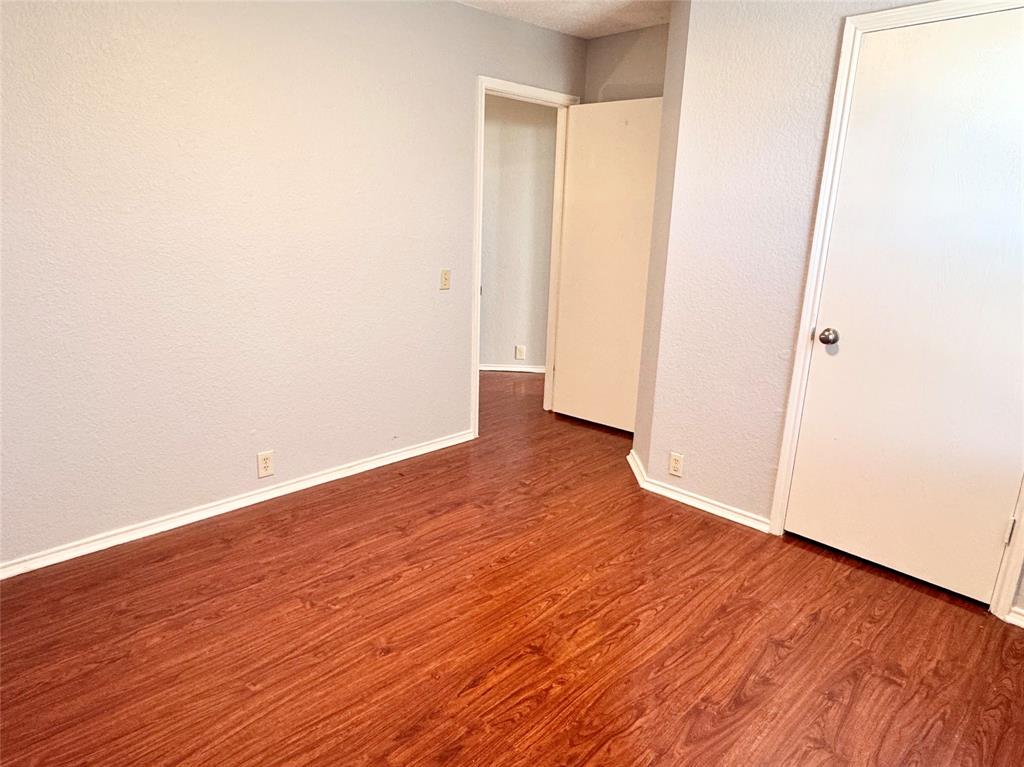 6723 Ambercrest Drive Arlington, TX 76002 - Photo 20 of 31 an empty room with wooden floor