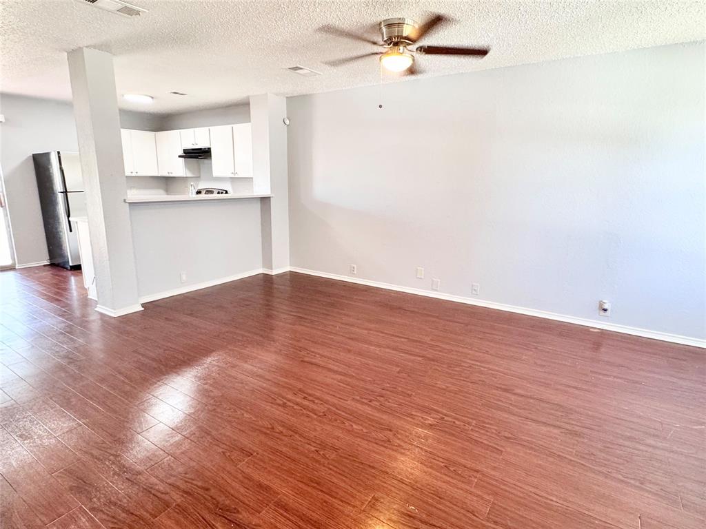 6723 Ambercrest Drive Arlington, TX 76002 - Photo 2 of 31 a view of a kitchen with wooden floor and a kitchen