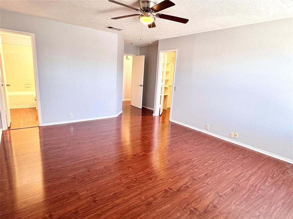 6723 Ambercrest Drive Arlington, TX 76002 - Photo 23 of 31 an empty room with wooden floor and windows