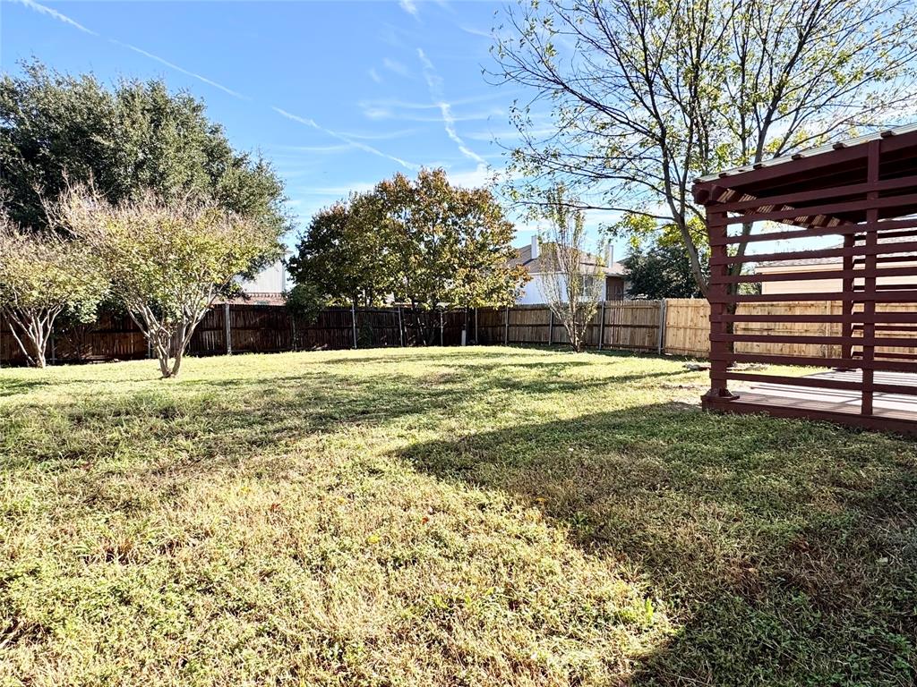 6723 Ambercrest Drive Arlington, TX 76002 - Photo 28 of 31 a view of a house with a yard