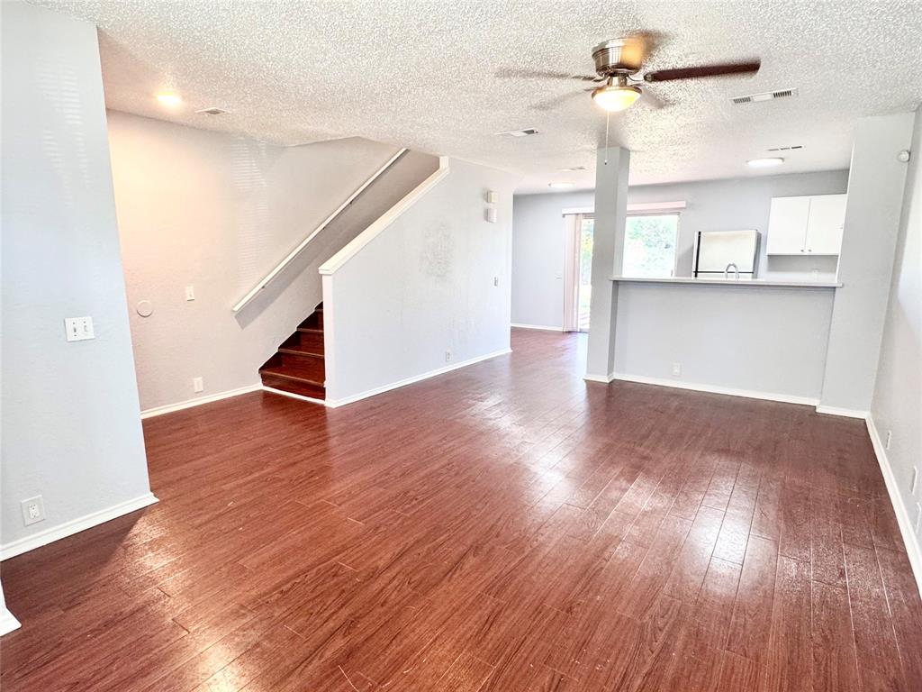 6723 Ambercrest Drive Arlington, TX 76002 - Photo 5 of 31 a view of an empty room with wooden floor and a window