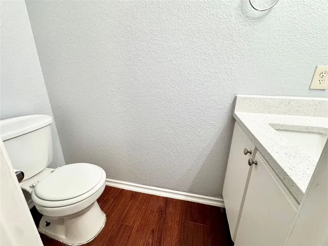 a white toilet sitting next to a sink