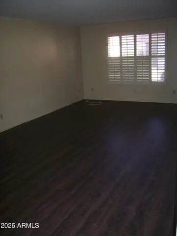 a view of wooden floor and windows in a room