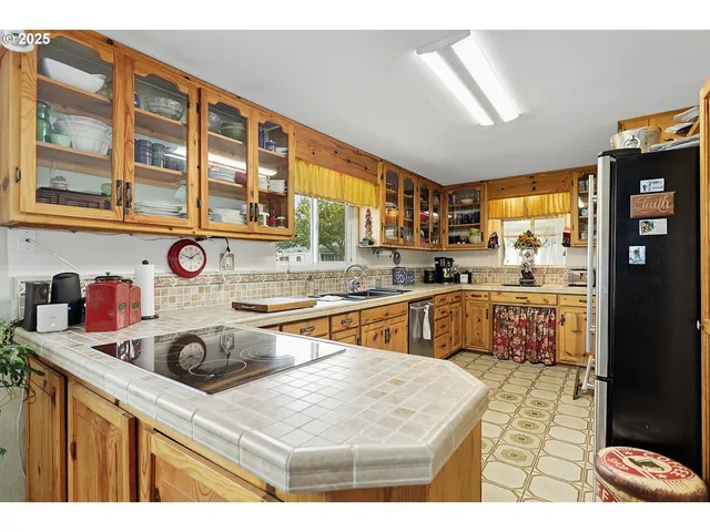 a kitchen with a stove a sink and a refrigerator