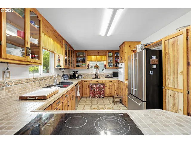 a kitchen with refrigerator and window
