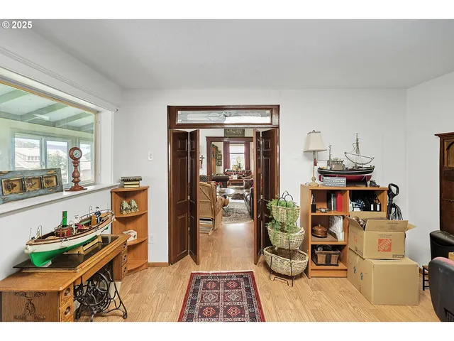 a living room with furniture a rug and kitchen view