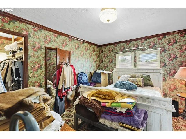 a bedroom with two beds and a large mirror