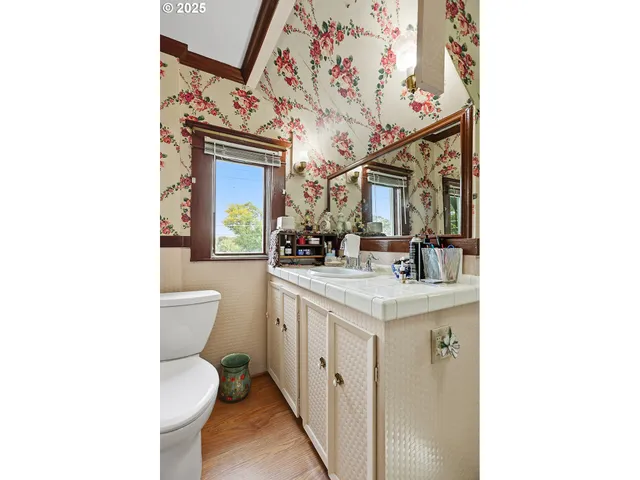 a bathroom with a toilet a sink and a mirror