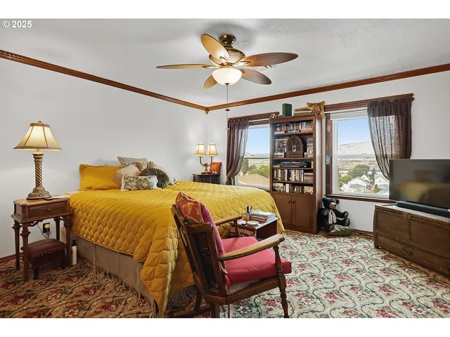 a bed room with a bed and a chair