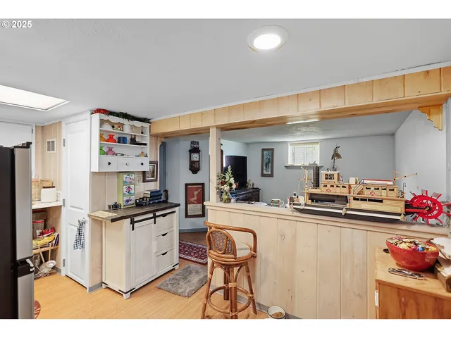 a kitchen with stainless steel appliances a stove top oven a chimney a dining table and chairs