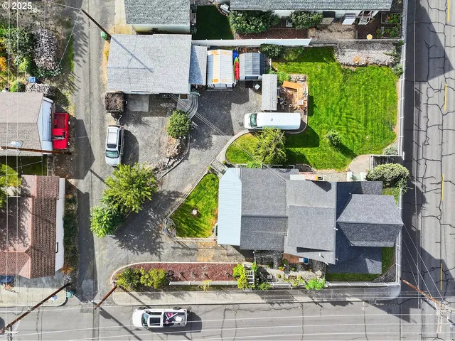 an aerial view of a house with garden space and street view