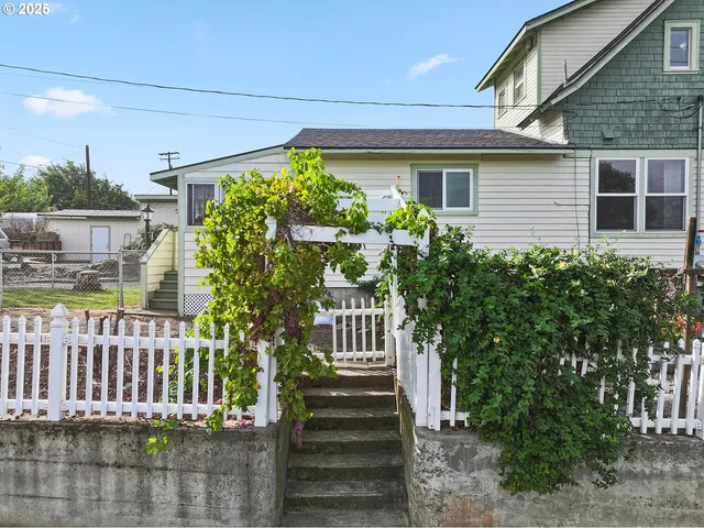 a front view of a house with a garden