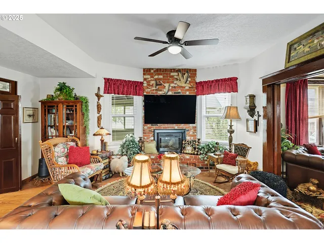 a living room with furniture a rug and a flat screen tv