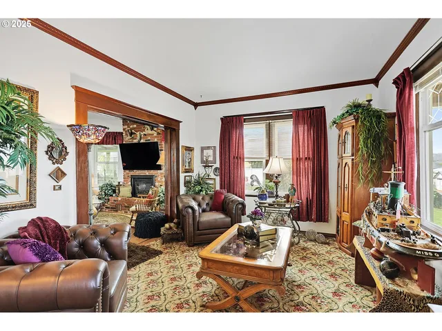 a living room with furniture a window and a flat screen tv