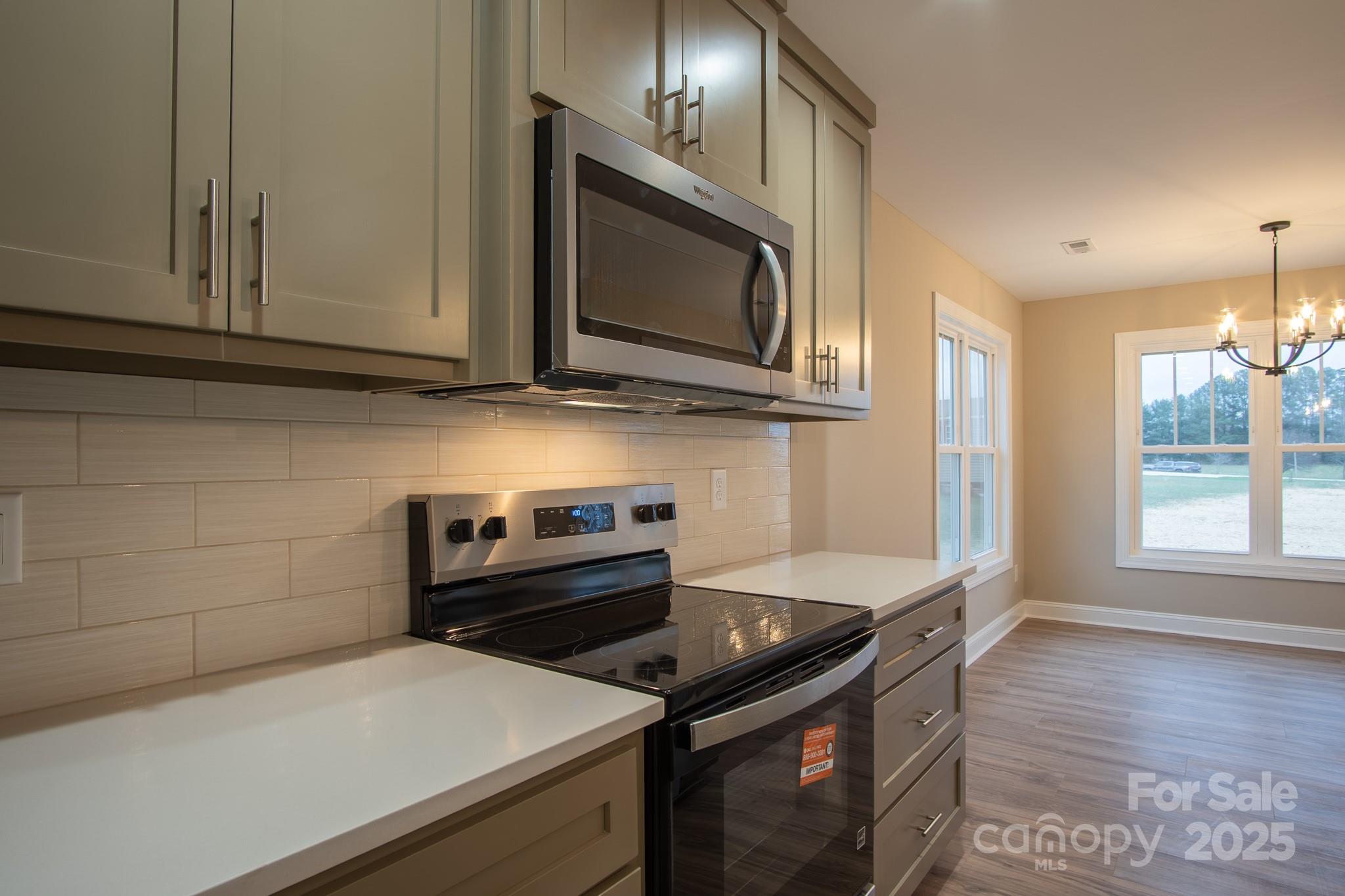 110 Alf Hoover Road Lincolnton, NC 28092 - Photo 12 of 35 a kitchen with a stove and a microwave