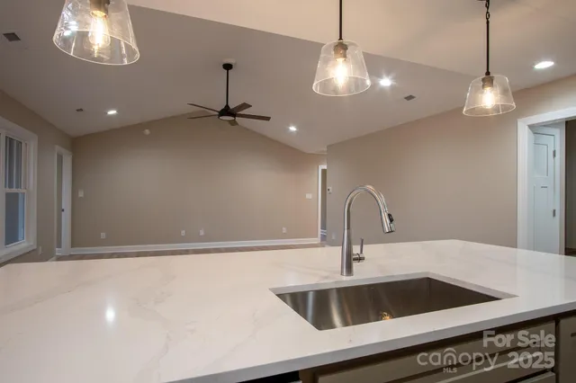 a kitchen with a sink and chandelier
