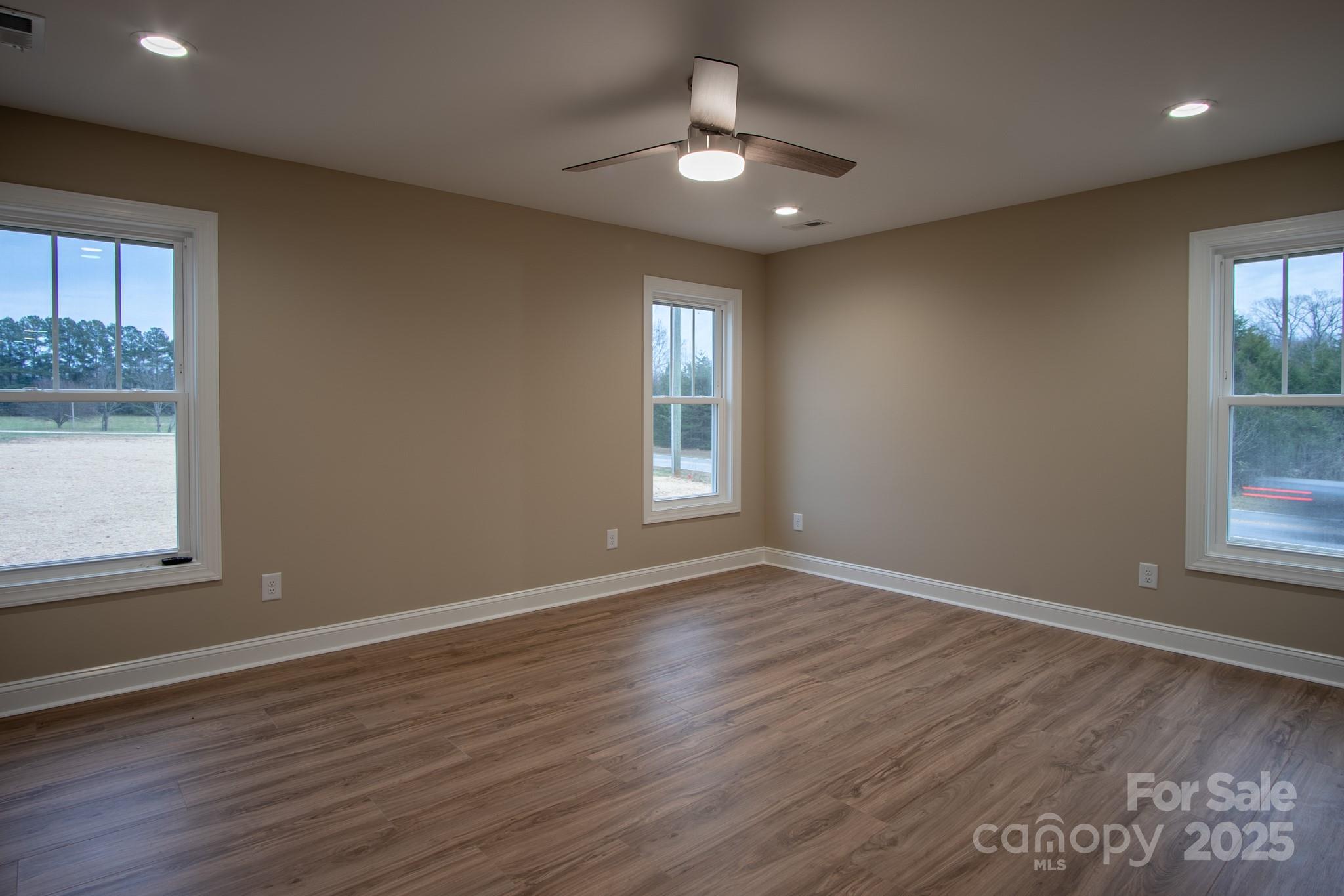 110 Alf Hoover Road Lincolnton, NC 28092 - Photo 23 of 35 an empty room with wooden floor and windows