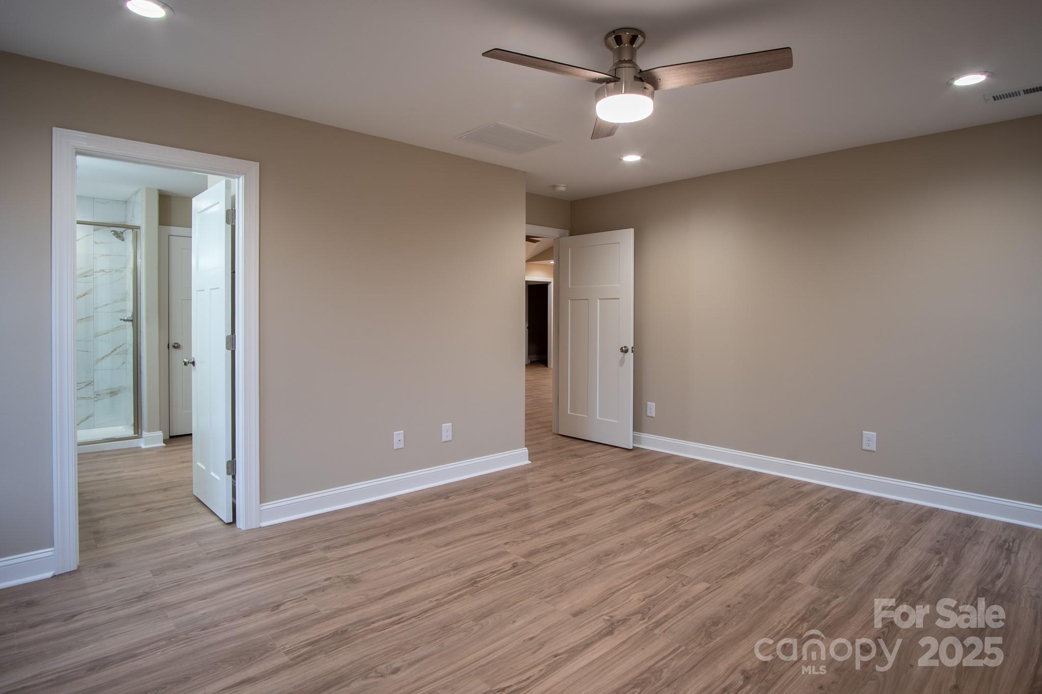 110 Alf Hoover Road Lincolnton, NC 28092 - Photo 24 of 35 wooden floor in an empty room with a ceiling fan
