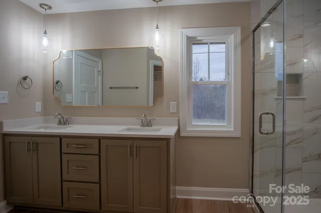a bathroom with a double vanity sink and mirror