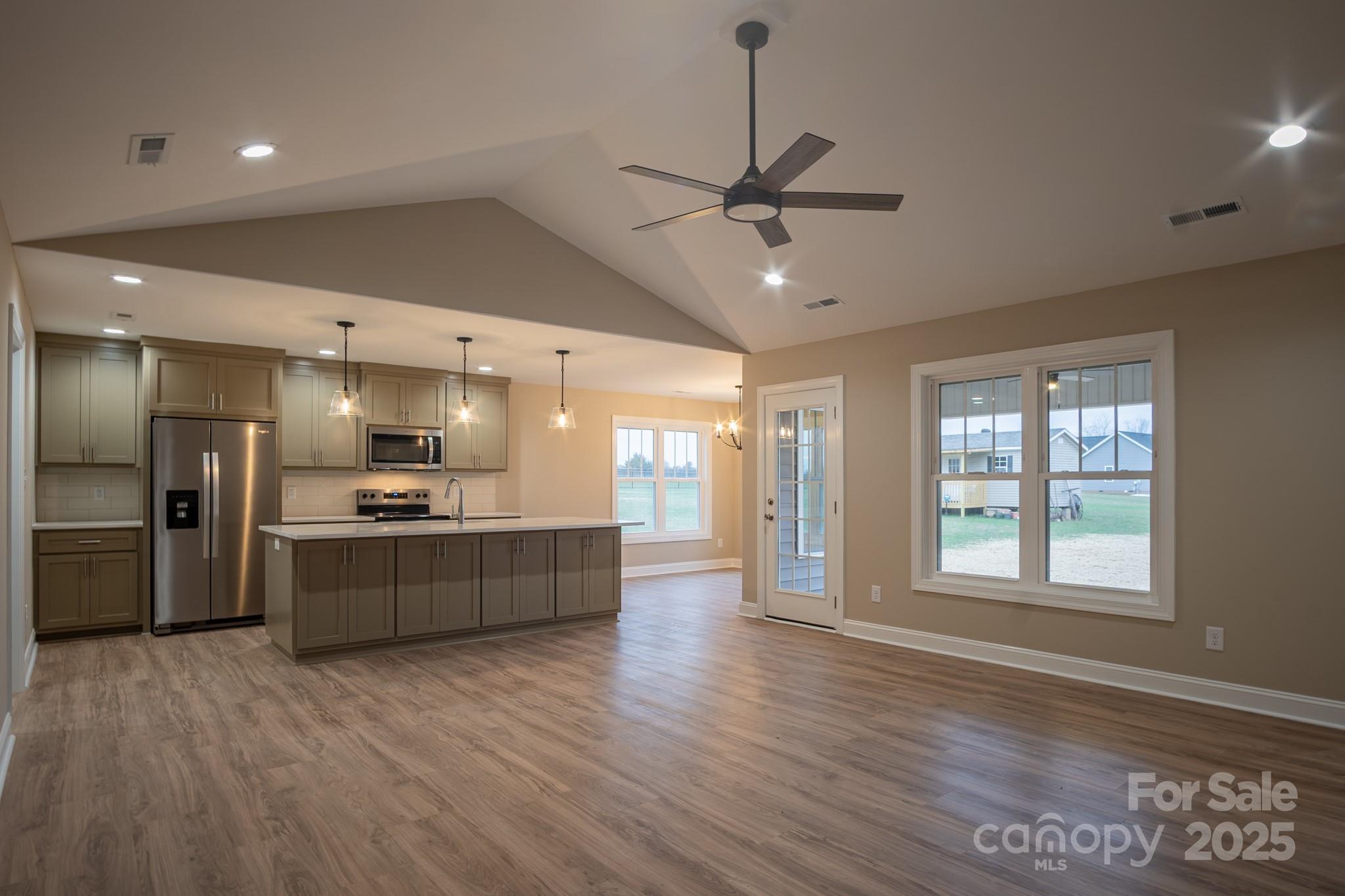 110 Alf Hoover Road Lincolnton, NC 28092 - Photo 9 of 35 a large kitchen with kitchen island a large counter space a sink stainless steel appliances and windows