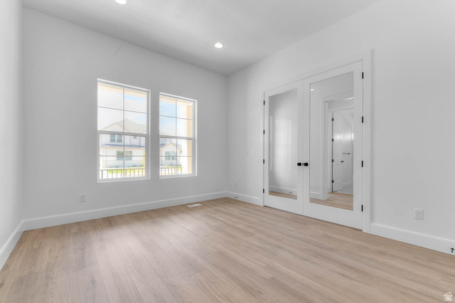 11711 South Halls Crk Road Draper, UT 84020 - Photo 11 of 31 Empty room featuring french doors, light wood-style flooring, and recessed lighting