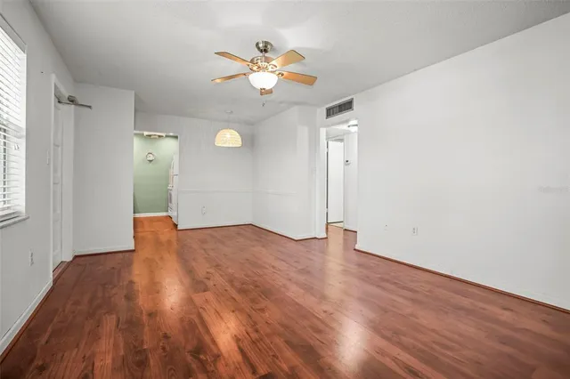 wooden floor in an empty room with a window