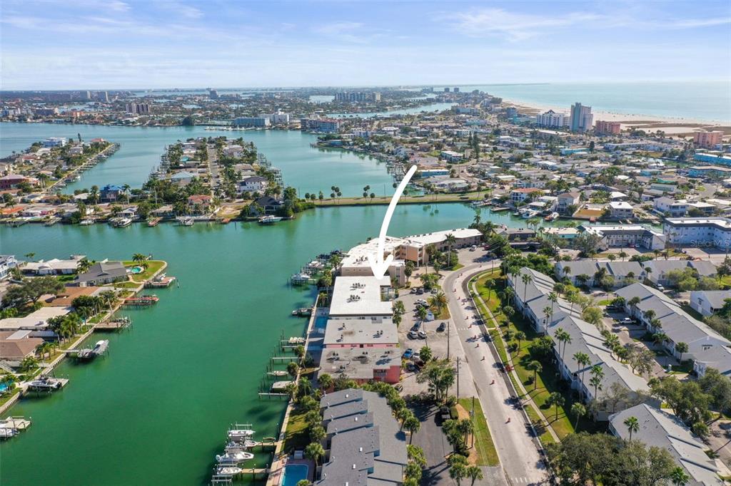 11655 3rd Street East, Unit 19 Treasure Island, FL 33706 - Photo 42 of 48 an aerial view of a city with lots of residential buildings ocean and mountain view in back