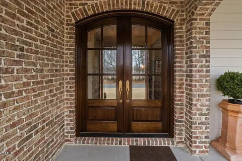 a view of a hallway with entryway wooden floor and front door