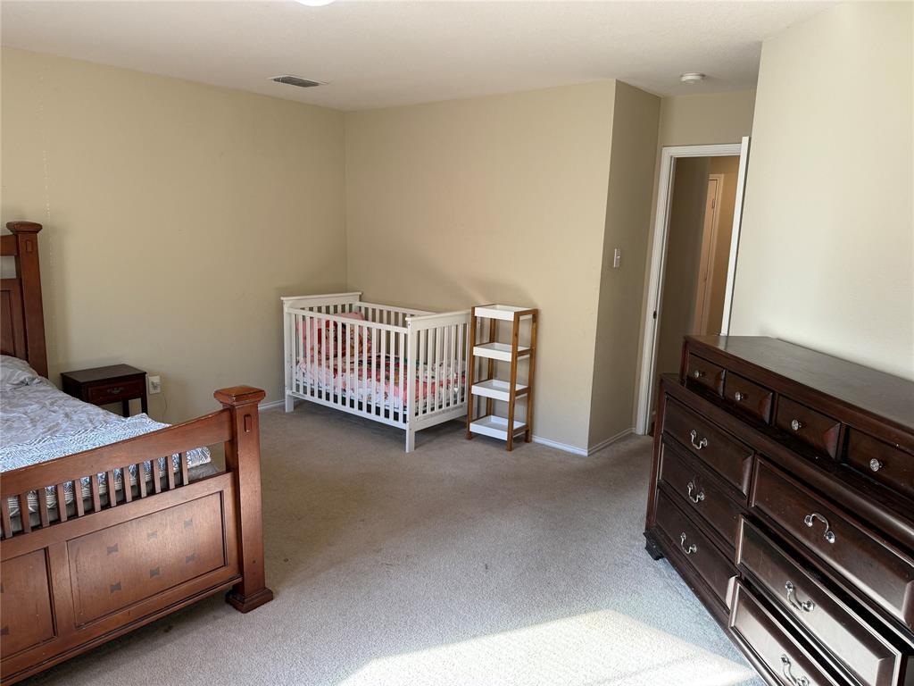 5718 Green Ivy Road Denton, TX 76210 - Photo 10 of 23 Bedroom featuring light colored carpet and baseboards
