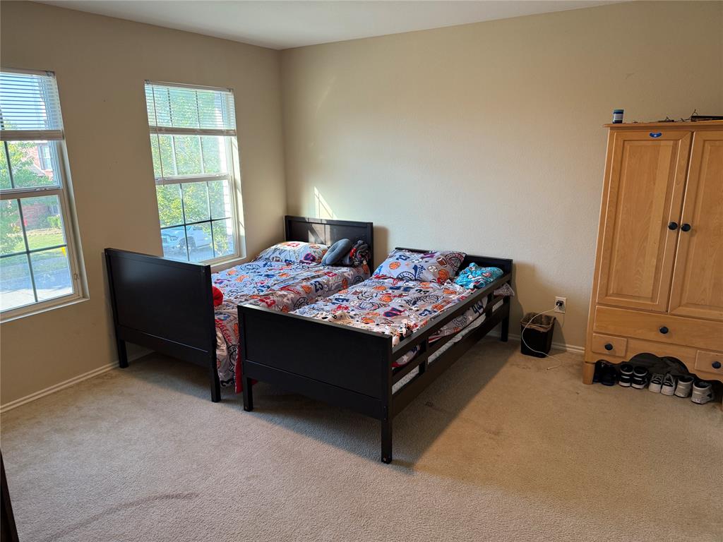 5718 Green Ivy Road Denton, TX 76210 - Photo 17 of 23 Bedroom with light carpet and baseboards