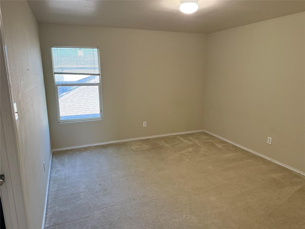 5718 Green Ivy Road Denton, TX 76210 - Photo 18 of 23 Unfurnished room featuring carpet and a textured ceiling