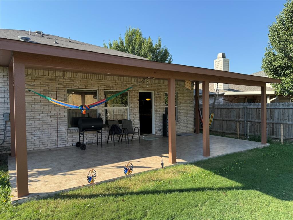 5718 Green Ivy Road Denton, TX 76210 - Photo 20 of 23 Back of property featuring brick siding, a patio, and a chimney