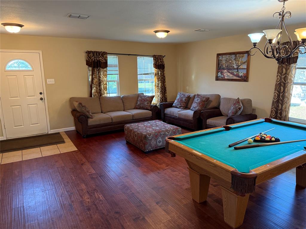 5718 Green Ivy Road Denton, TX 76210 - Photo 3 of 23 Rec room with billiards, wood finished floors, and a chandelier