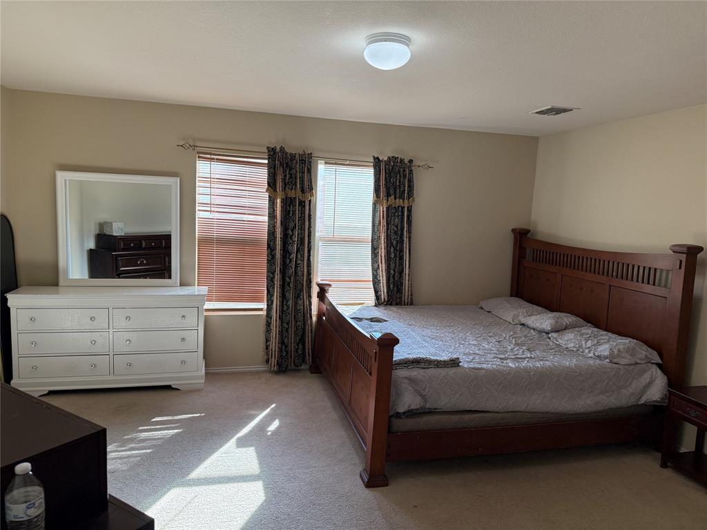 5718 Green Ivy Road Denton, TX 76210 - Photo 9 of 23 Bedroom with light carpet
