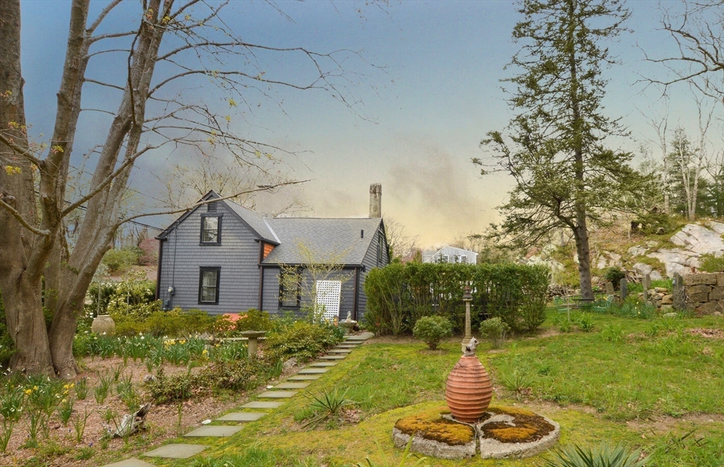1150 Russells Mills Road Dartmouth, MA 02748 - Photo 2 of 31 a front view of a house with a yard fountain and trees