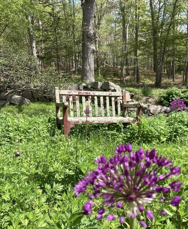 1150 Russells Mills Road Dartmouth, MA 02748 - Photo 25 of 31 a view of a house with large trees and plants
