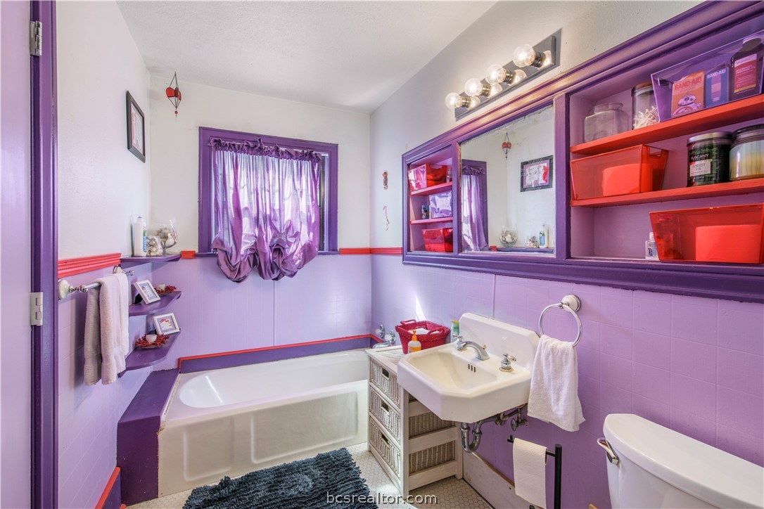 706 Edgemore Drive Bryan, TX 77802 - Photo 12 of 18 a bathroom with a sink toilet vanity and tub
