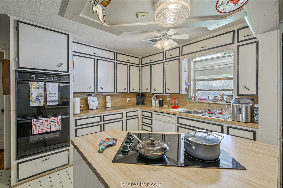 706 Edgemore Drive Bryan, TX 77802 - Photo 16 of 18 a kitchen with stainless steel appliances granite countertop a sink and cabinets