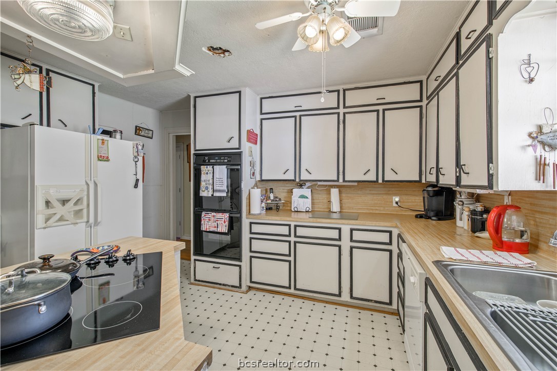 706 Edgemore Drive Bryan, TX 77802 - Photo 17 of 18 a kitchen with stainless steel appliances a stove a sink and a refrigerator