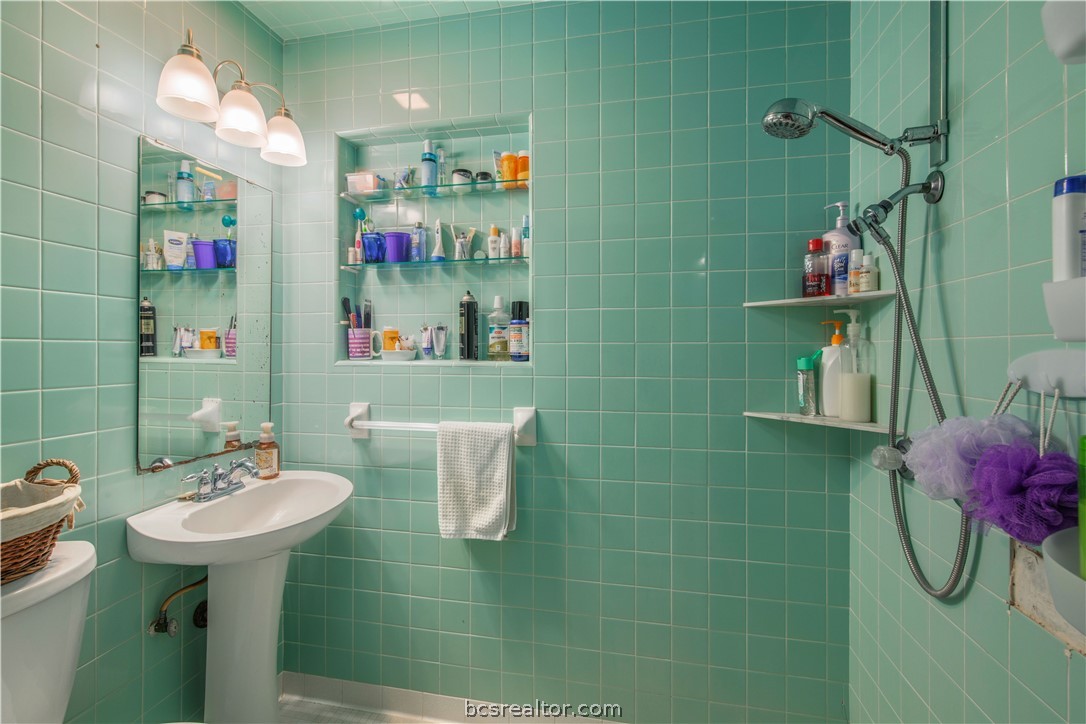 706 Edgemore Drive Bryan, TX 77802 - Photo 9 of 18 a bathroom with a sink mirror and shower