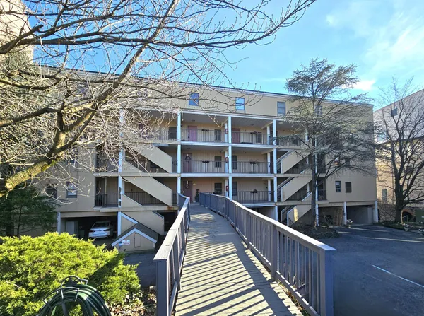 a view of a house with a small deck