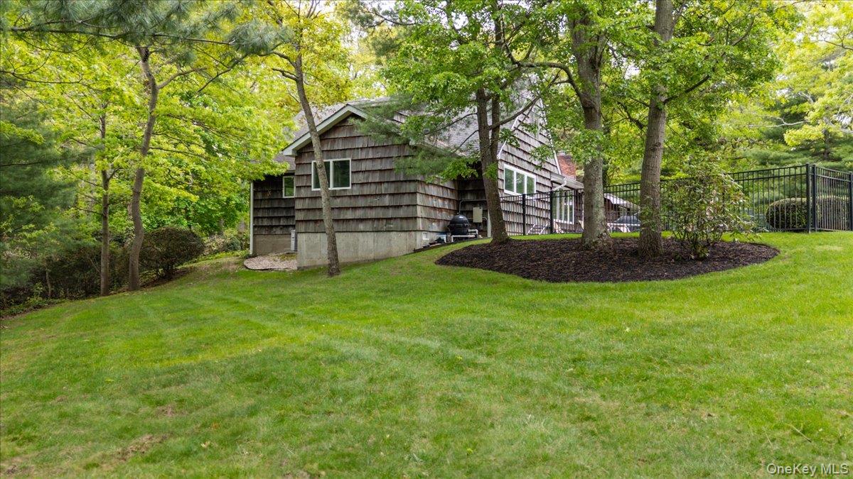 6 Apex Road Melville, NY 11747 - Photo 39 of 50 a view of a backyard with plants and large tree