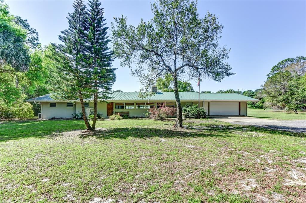 211 Angeles Road DeBary, FL 32713 - Photo 1 of 1 a view of a house with yard and a tree