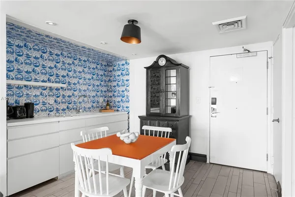 a dining room with a table and chairs