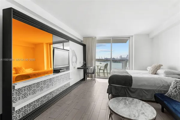 a bedroom with a bed and glass walk in closet