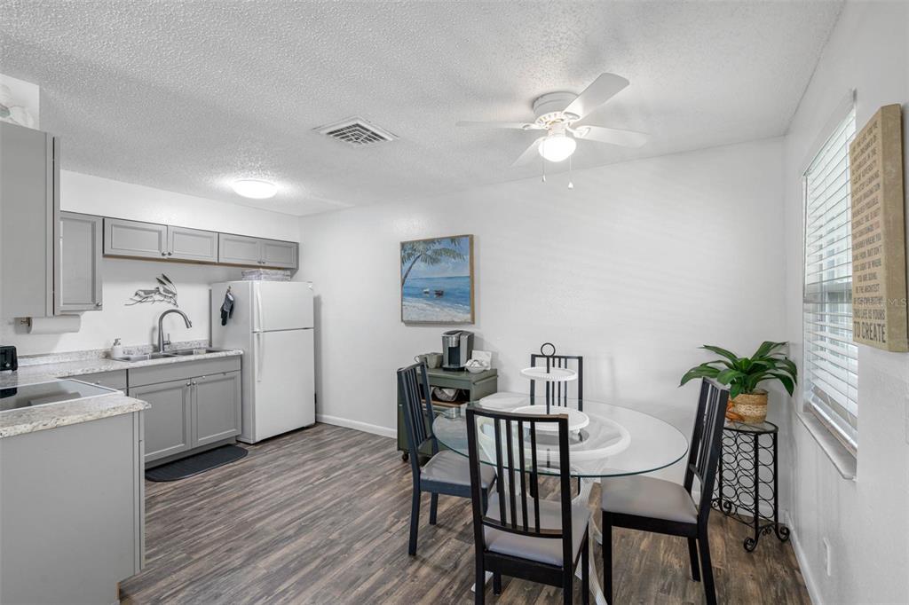 115 15th Avenue, Unit A Indian Rocks Beach, FL 33785 - Photo 11 of 65 a kitchen that has a table and chairs in it