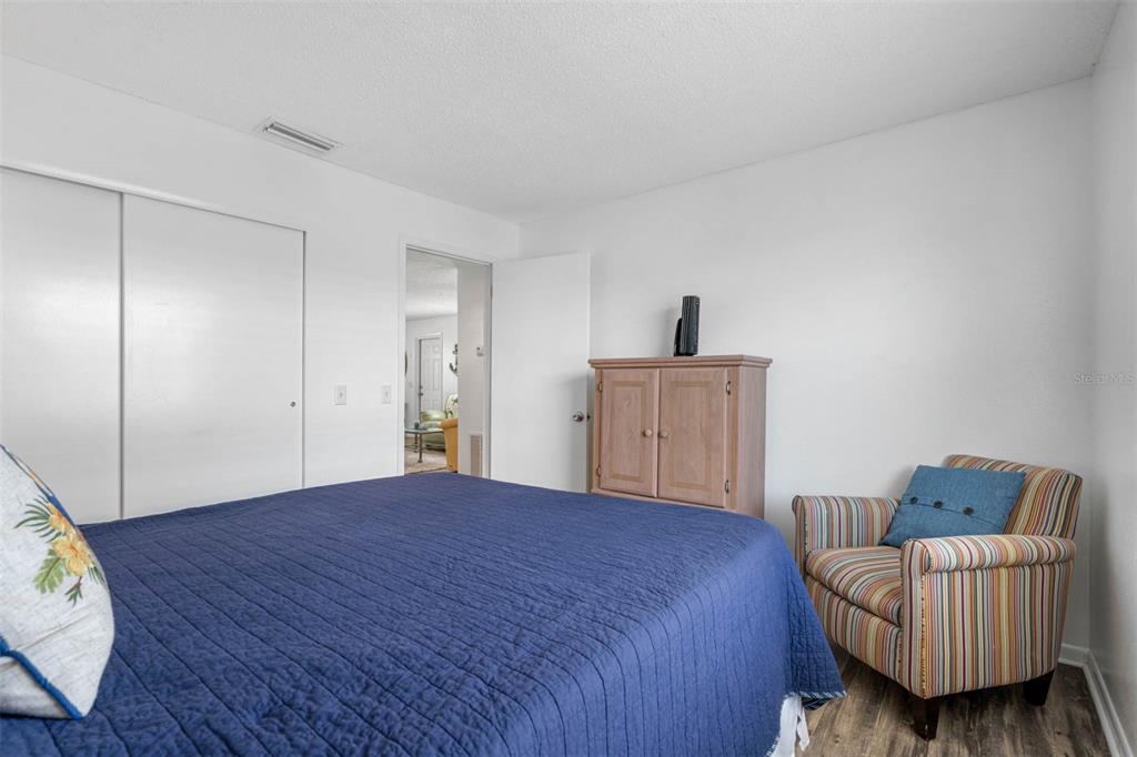 115 15th Avenue, Unit A Indian Rocks Beach, FL 33785 - Photo 21 of 65 a spacious bedroom with a bed and a couch