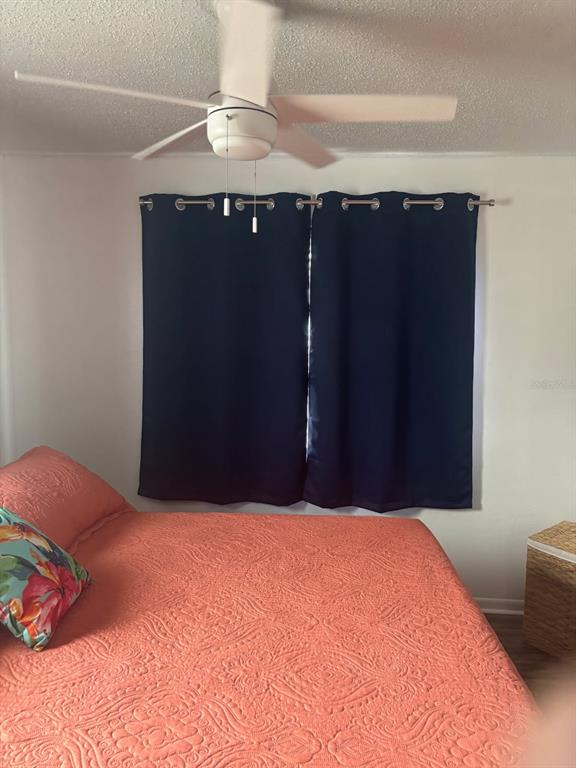 115 15th Avenue, Unit A Indian Rocks Beach, FL 33785 - Photo 23 of 65 a bedroom with a bed and a cabinets