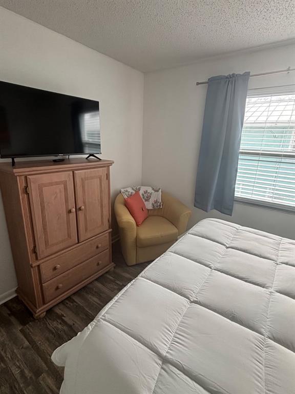 115 15th Avenue, Unit A Indian Rocks Beach, FL 33785 - Photo 24 of 65 a bedroom with a bed and flat screen tv