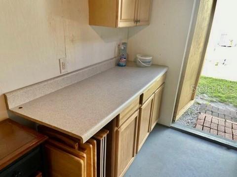 115 15th Avenue, Unit A Indian Rocks Beach, FL 33785 - Photo 29 of 65 a kitchen with a sink and cabinets
